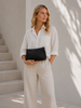 Clutch skinnveske med perforert mønster